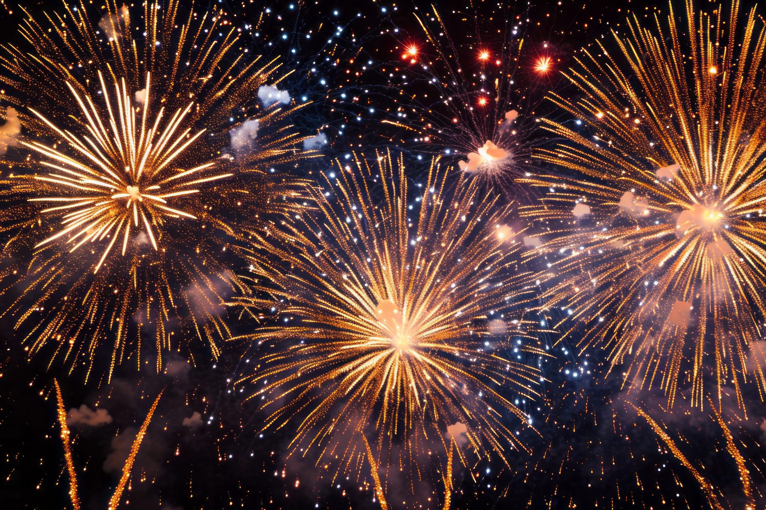 A dazzling display of golden fireworks illuminates the night sky
